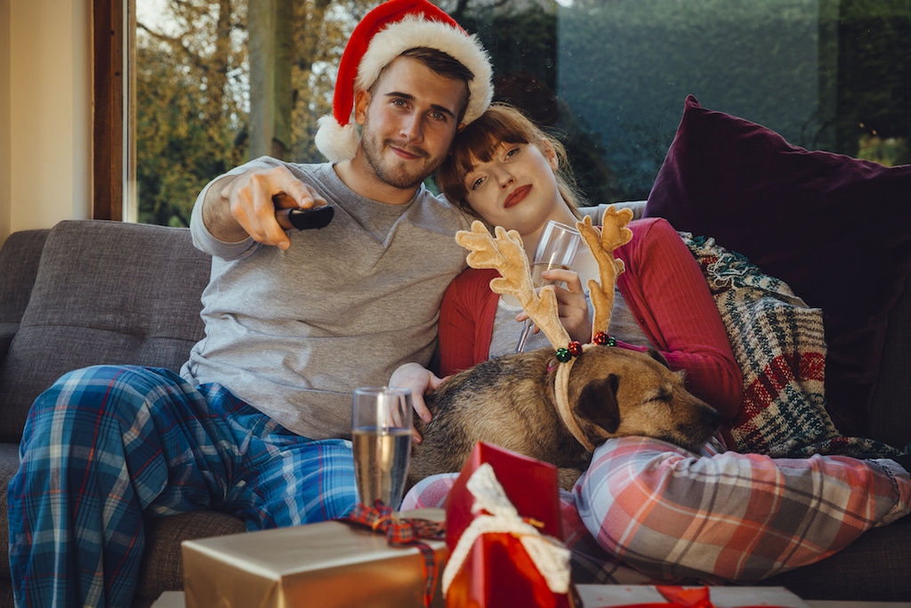 Couple on couch in casual holiday clothes